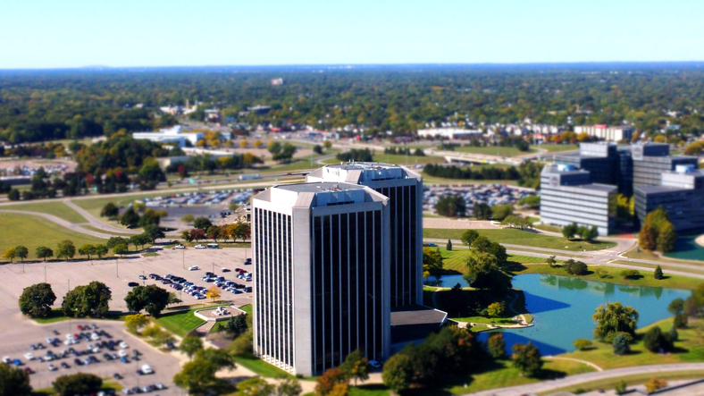 Parklane Towers office buildings in Dearborn, Michigan, near Regent Court, with parking areas, trees, and a small pond visible from above.