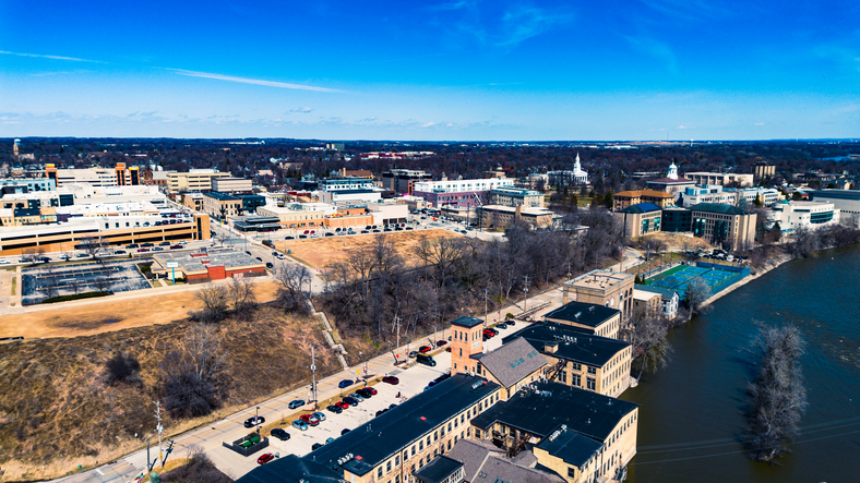 Aerial Photograph of Appleton Wisconsin downtown with the Fox River passing through the lower part of the frame on a partly cloudy day.